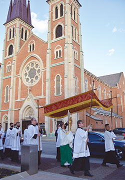A eucharistic procession with Archbishop Charles C. Thompson holding a monstrance files past St. John the Evangelist Church in Indianapolis during the National Catholic Youth Conference in Indianapolis on Nov. 18. (Photo by Natalie Hoefer)