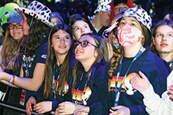 Youths from Holy Family Parish in New Albany take in the sights and sounds of the Saturday morning general session of the National Catholic Youth Conference on Nov. 20 at Lucas Oil Stadium in Indianapolis. (Photo by Sean Gallagher)
