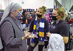 Society of Our Lady of the Trinity Sister Mary Claire Strasser, left, chats with Sofia Sauls, center, and Ava Glemming, both of the Archdiocese of Oklahoma City, Okla. (Photo by Sean Gallagher)