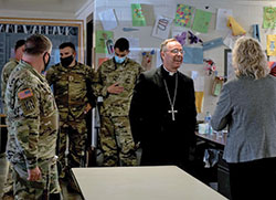 Archbishop Charles C. Thompson visits with Team Rubicon members supporting Operation Allies Welcome at Camp Atterbury on Nov. 4. The U.S. Conference of Catholic Bishops offers activities and programs for Afghan guests to boost morale as they await resettlement at Camp Atterbury. This initiative provides essential support at secure locations outside of Afghanistan. The Department of Defense, through U.S. Northern Command, and in support of the Department of Homeland Security, is providing transportation, temporary housing, medical screening and general support for at least 50,000 Afghan evacuees at suitable facilities in permanent or temporary structures as quickly as possible. (U.S. Army photo by Sgt. Trinity Carter/14th Public Affairs Detachment)
