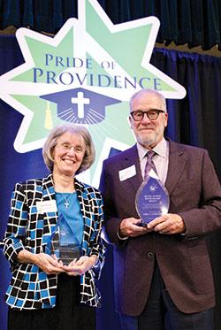 Providence Sister Jeanne Hagelskamp and John Lechleiter pose on Oct. 22 during a fundraising event for Providence Cristo Rey High School in Indianapolis with awards that the school gave them during the event for their role in its founding. (Submitted photo)