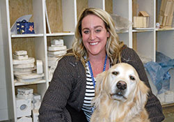 Katherine Eckart and her certified therapy dog Millie make a joyful and relaxing team in art classes at Bishop Chatard High School in Indianapolis. (Photo by John Shaughnessy)