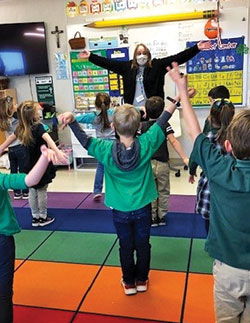 Social worker Patrice Uminski leads pre-school students at St. Malachy School in Brownsburg in practicing taking “mountain breaths” to help them calm down when they struggle with their motions. (Submitted photo)