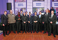 Archbishop Charles C. Thompson poses for a photo with some of the archdiocesan seminarians at the Legacy Gala at the JW Marriott hotel in Indianapolis on Feb. 25. (Photo by Rob Banayote)