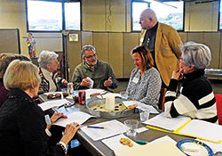 Ken Ogorek listens as Tom Feick, center, raises a point with a small group during a March 5 meeting at St. Bartholomew Parish in Columbus at which a draft report on a synodal process in the archdiocese that started last October was reviewed. Feick and the others at the table are members of St. Luke the Evangelist Parish in Indianapolis. The others include Judy Corbett, third from left, Gayle Spencer and Marcia Capuano. Ogorek coordinated the synodal process in the archdiocese. (Photo by Sean Gallagher)
