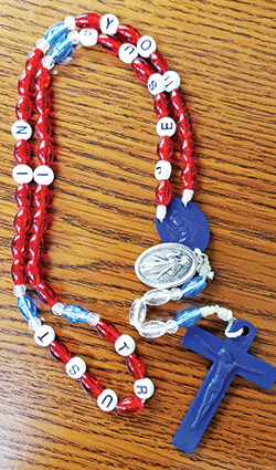A Divine Mercy chaplet with beads spelling out “Jesus I Trust in You” is shown here. The chaplet was made by Kathy Eberle of St. John Paul II Parish in Sellersburg. (Photo by Natalie Hoefer)