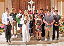 Archbishop Charles C. Thompson poses for a photo with many of the teens who received 2022 Spirit of Youth Awards from the archdiocese’s Catholic Youth Organization on May 3. (Photo by Michaela Ward of the CYO)
