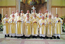 Fifteen newly ordained permanent deacons pose on June 25 in SS. Peter and Paul Cathedral in Indianapolis moments after the Mass in which they were ordained for service in the archdiocese. (Photo by Sean Gallagher)