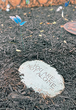 During the You Are Not Alone retreat for survivors of suicide loss, butterflies are placed in a memorial garden at Our Lady of Fatima Retreat House. (Submitted photo)