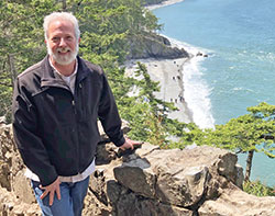 John Mundell poses for a photo against the backdrop of the Puget Sound in the state of Washington. (Submitted photo)