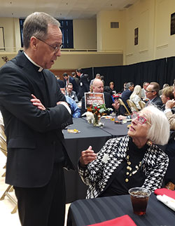 Archbishop Charles C. Thompson speaks with Christina Kellams at a reception in the Archbishop Edward T. O’Meara Catholic Center in Indianapolis on Oct. 4. (Photo by Natalie Hoefer)