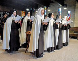 Discalced Carmelite nuns of the Monastery of St. Joseph in Terre Haute sing on Oct. 8 during a Mass to celebrate the 75th anniversary of the founding of their community. (Photo by Sean Gallagher)