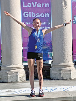 Lily Cridge of Bishop Chatard High School in Indianapolis celebrates finishing first—for the second year in a row—in the Indiana girls’ high school cross-country state championship race on Oct. 29 in Terre Haute. (Submitted photo)