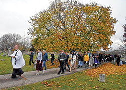Father C. Ryan McCarthy, pastor of Our Lady of the Most Holy Rosary Parish in Indianapolis, leads Catholics on Nov. 5 in his parish’s eighth annual Indulgence Walk through Holy Cross and St. Joseph cemeteries in Indianapolis. (Photo by Sean Gallagher)