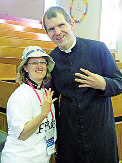 In this July 17, 2008, photo from World Youth Day (WYD) in Sydney, Australia, Trina Trusty and Father Jonathan Meyer hold up four fingers indicating their fourth attendance at a WYD gathering. The late Pope Benedict XVI was present for WYD 2005, 2008 and 2011. (File photo)
