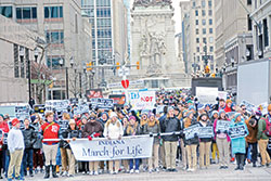 The front half of an estimated 1,000 participants in the Indiana March for Life in Indianapolis on Jan. 24, 2022, heads toward the Indiana Statehouse for a pro-life rally. The other half wrap around the south side of the Soldiers and Sailors Monument seen in the background. (File photo by Natalie Hoefer)