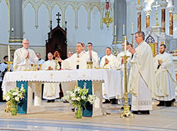 Bishop Joseph M. Siegel of the Evansville, Ind., Diocese, left, Archbishop Charles C. Thompson, center, and Bishop Timothy L. Doherty, of the Lafayette, Ind., Diocese, right, and several priests concelebrate a Mass at St. John the Evangelist Church in Indianapolis before the Indiana March for Life on Jan. 23. (Photo by Natalie Hoefer)