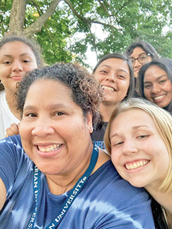 As the smiles of some of her students at Marian University in Indianapolis show, Rolanda Hardin, forefront, has always had a way of sharing joy and kindness with young people. (Submitted photo)