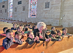 Kelly England, principal of St. Philip Neri School in Indianapolis, prays the rosary with students. (Submitted photo)