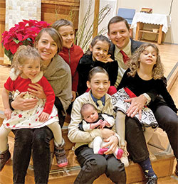 Paul Sifuentes, the new executive director of pastoral ministries for the archdiocese, and his wife Alexa pose for a photo with their six children: Luke, Victoria, Peter, Natalie, Regina and Maria. (Submitted photo)