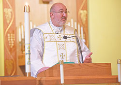 Father Daniel Mahan, priest in solidum in the four parishes in Dearborn County, preaches a homily during an April 27 Mass at St. Mary of the Immaculate Conception Church in Aurora. (Photo by Sean Gallagher)