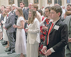 The Langdon family prepare to receive the sacrament of confirmation during the Easter Vigil Mass at St. Lawrence Church in Lawrenceburg on April 8. They are, from left, Steven, Stephanie, Will, Maria, Julie and Alex. (Submitted photo by L.J. Stange)
