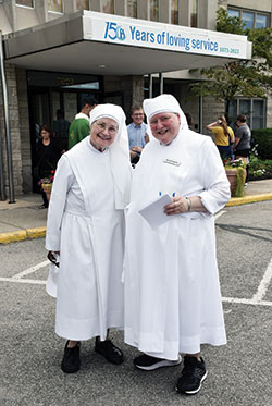 Sister Celestine Meade, left, and Sister Raymond Korterhof, both members of the Little Sisters of the Poor, smile outside the St. Augustine Home during an event marking the Little Sisters’ 150 years of service in central Indiana on Aug. 26. (Photo by Natalie Hoefer)