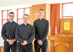 Seminarians Isaac Siefker, left, Samuel Hansen and Casey Deal stand on Oct. 11 by the tabernacle in the St. Theodore Guérin Chapel at Saint Meinrad Seminary and School of Theology in St. Meinrad. (Photo courtesy of Saint Meinrad Archabbey)