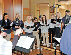 A choir from Roncalli High School in Indianapolis lead the singing during the archdiocesan High School Senior Mass at St. Malachy Church in Brownsburg on Nov. 29. (Photo by John Shaughnessy)