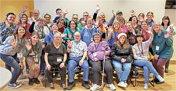 Participants and volunteers wave at the camera during the Special Religious Education and Discipleship Advent retreat at St. Mark the Evangelist Parish in Indianapolis on Dec. 2.