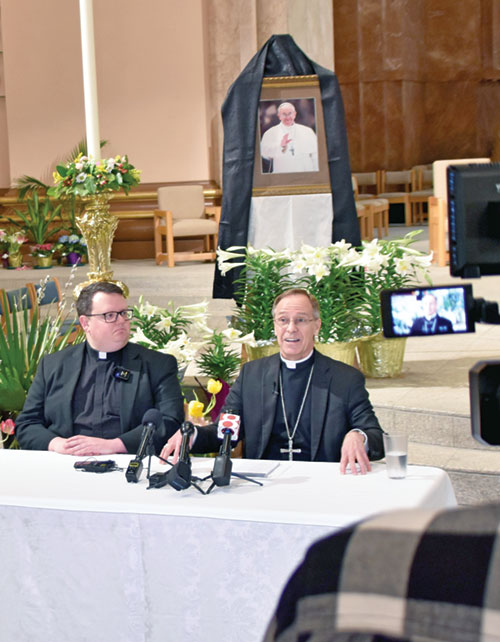In SS. Peter and Paul Cathedral in Indianapolis on April 22, Archbishop Charles C. Thompson responds to a reporter’s question during a press conference regarding the death of Pope Francis. At left is Father James Brockmeier, rector of the cathedral and director of the archdiocesan Office of Worship. (Photo by Natalie Hoefer)