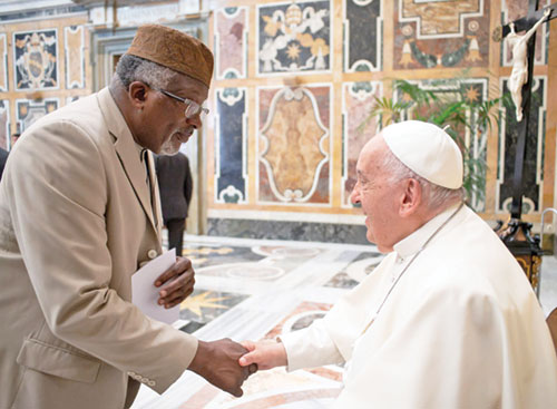 Michael Saahir, imam of the Nur-Allah Islamic Center in Indianapolis, greets Pope Francis on June 3, 2024, at the Vatican during an interfaith dialogue meeting held in Rome. (Submitted photo)