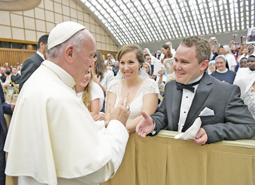 Elisabeth and Scott Williams smile in complete joy as they meet Pope Francis at the Vatican on Aug. 3, 2016. Married on May 28 in that year, the couple later traveled to Rome after they learned about the long-standing tradition of popes offering a blessing to newlyweds. (Photo courtesy of L’Osservatore Romano)
