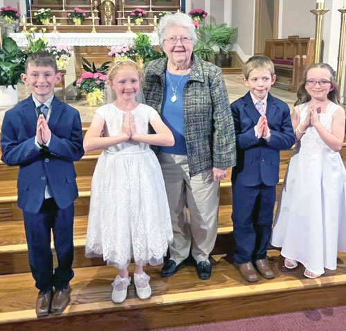Betty Ripberger experiences the joy of being with four of her great-grandchildren—Camden, left, Emarie, Joel and Leah—on the day they received their first Communion at St. Mary Church in Rushville on May 4. (Submitted photo)