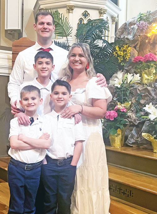 Cole and Christina May smile with their sons Harrison, front row left, Maxwell, front row right, and David, center, after being welcomed into the full communion of the Church during the April 19 Easter Vigil Mass in Yorkville at St. Martin Church of All Saints Parish. (Submitted photo)
