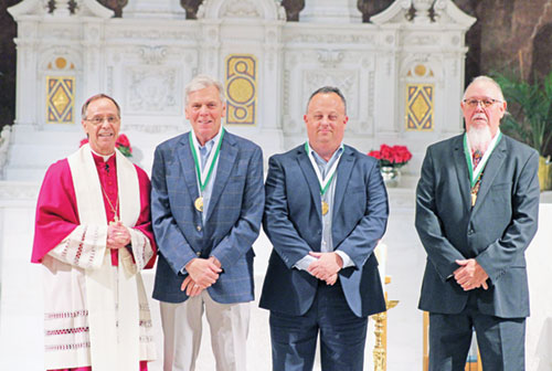 Archbishop Charles C. Thompson shares a moment of celebration with John Bannister, left, Kevin Kirkhoff and Randall Herrman, this year’s recipients of the St. John Bosco Medal, the highest honor the archdiocese’s Catholic Youth Organization gives an individual. (Photo courtesy of Zoe Hawkins)