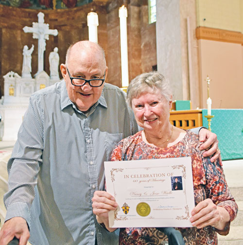 After the archdiocese’s annual Wedding Anniversary Mass at SS. Peter and Paul Cathedral in Indianapolis on Aug. 24, Jesse and Nancy Wadle smile with a copy of a certificate honoring their 60th anniversary. See more wedding anniversaries on pages 9 and 10. (Photo by Natalie Hoefer)