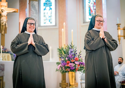 Franciscan Sister Mary Peter Ruschke, left, and Franciscan Sister Mary Amata Naville beam with joy on Aug. 2 while receiving the congratulations of those present for their profession of perpetual vows as members of the Sisters of St. Francis of Perpetual Adoration in the community’s motherhouse chapel in Mishawaka, Ind., in the Fort Wayne-South Bend Diocese. Sister Mary Peter was previously a teacher at St. Louis School in Batesville. Sister Mary Amata grew up as a member of St. Mary Parish in Navilleton and was a student at Holy Family School in New Albany. (Submitted photo)