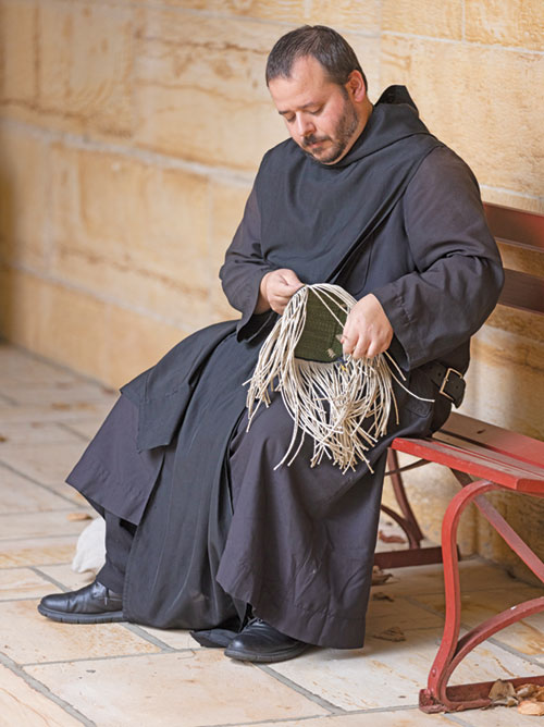 Benedictine Brother Jean Fish works on Oct. 10 on a piece of woven art on the grounds of Saint Meinrad Archabbey in St. Meinrad. (Photo courtesy of Saint Meinrad Archabbey)