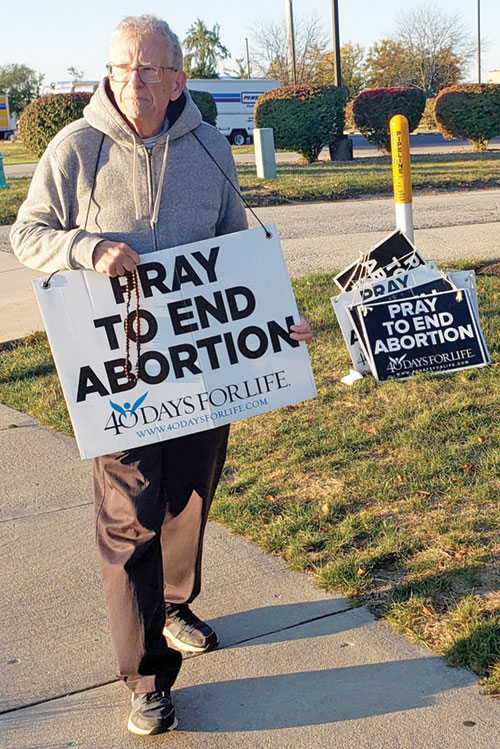 Steve Martin of St. Monica Parish in Indianapolis prays in front of a Planned Parenthood facility within his parish’s boundaries on Oct. 22—five days before turning 80 and stepping down as St. Monica’s pro-life committee chair after 49 years. (Photo by Natalie Hoefer)