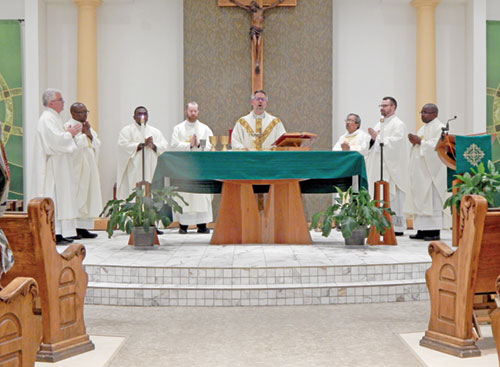 Clergy pray during a Nov. 3 Mass at Holy Angels Church in Indianapolis marking the feast of St. Martin de Porres. (Photo by Mike Krokos)