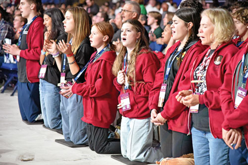 National Catholic Youth Conference participants from the Diocese of Charleston, S.C., kneel in prayer during the event’s closing Mass on Nov. 22 in Lucas Oil Stadium in Indianapolis. (Photo by Sean Gallagher)