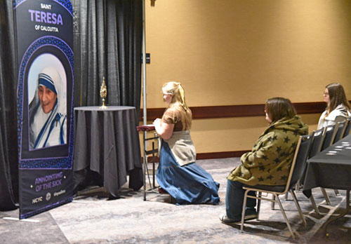 People pray in the relic chapel at the National Catholic Youth Conference in Indianapolis in November 2025. (Photo by Sean Gallagher)
