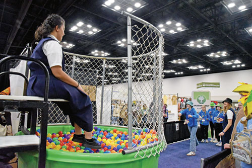 Alana Brooks-Murphy, an aspirant in the Salesian Sisters, sits atop a dunk tank on Nov. 20 in her religious community’s booth in the Indiana Convention Center in Indianapolis during the National Catholic Youth Conference held from Nov. 20-22. Some 16,000 Catholic teenagers from across the country came to Indianapolis for the conference. (Photo by Sean Gallagher)
