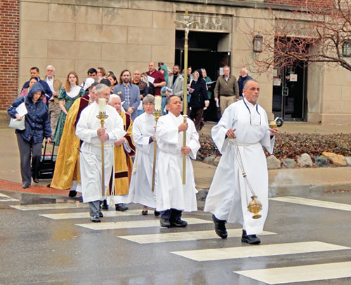 People process across Meridian Street from the Archbishop Edward T. O&rsquo;Meara Catholic Center to SS. Peter and Paul Cathedral on Dec. 29, 2024, after a prayer service to mark the start of the 2025 Jubilee Year, whose theme is &ldquo;Pilgrims of Hope.&rdquo; (File photo by Mike Krokos)