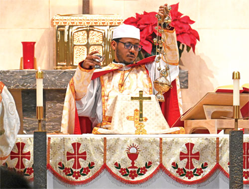 Vincentian Father Haile Suba, a priest from Eritrea temporarily studying in New York, incenses the altar in St. Michael the Archangel Church in Indianapolis on Jan. 10 during a Mass in the Ge&rsquo;ez rite celebrating Christmas for the Eritreans and Ethiopians who are members of the westside parish. (Photo by Natalie Hoefer)