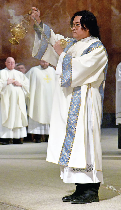 Transitional Deacon Timothy Khuishing swings a thurible on March 31 at SS. Peter and Paul Cathedral in Indianapolis during the archdiocese&rsquo;s annual chrism Mass. He and two other transitional deacons will be ordained priests on June 6 at the cathedral. (Photo by Sean Gallagher)