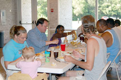 Photo caption: Volunteers and guests share a meal at St. Elizabeth Ann Seton Parish, Carmel. The parish recently hosted three families in the Interfaith Hospitality Network program. (Photo by Caroline B. Mooney)