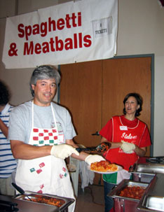 Photo caption: Andy BeNardo and Carla Erickson work at the spaghetti and meatballs station. Organizers expected between 2,000 and 2,500 hungry festival-goers this year. (Photo by Katy Harrison Troxell) 
