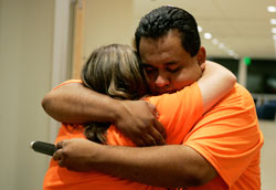 Alfredo “Pepe” Flores-Carillo, emcee for Catholic Youth Xperience, embraces a CYX participant following a Reconciliation service in the Harre Union building on the campus of Valparaiso University, July 31. Nearly 200 teens attended the sixth annual diocesan summer retreat for high school students. (Tim Hunt photo)